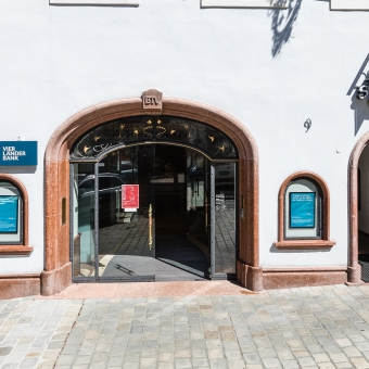 Außenansicht der BTV Bank Filiale in Kitzbühel mit der Adresse Vorderstadt 9, neben dem Eingang befindet sich ein Bankomat