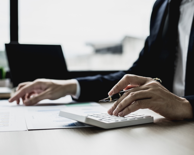 A business person uses a calculator